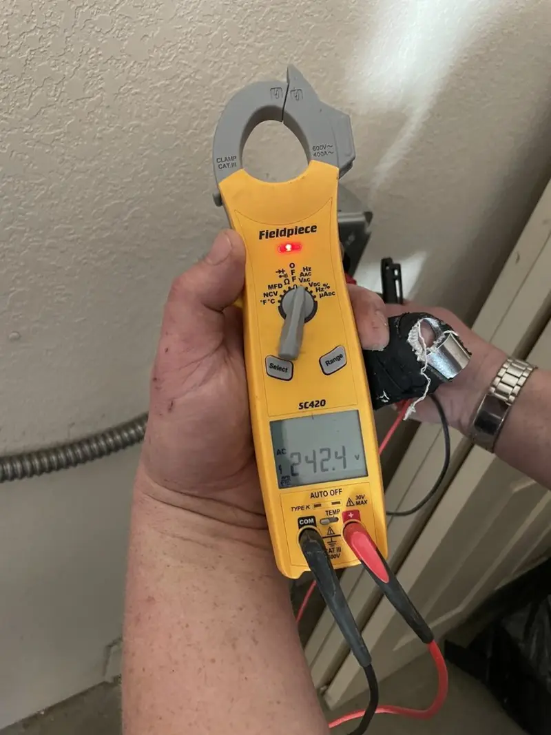 Voltage testing with clamp meter during Ceiling Fan Installation in Tea